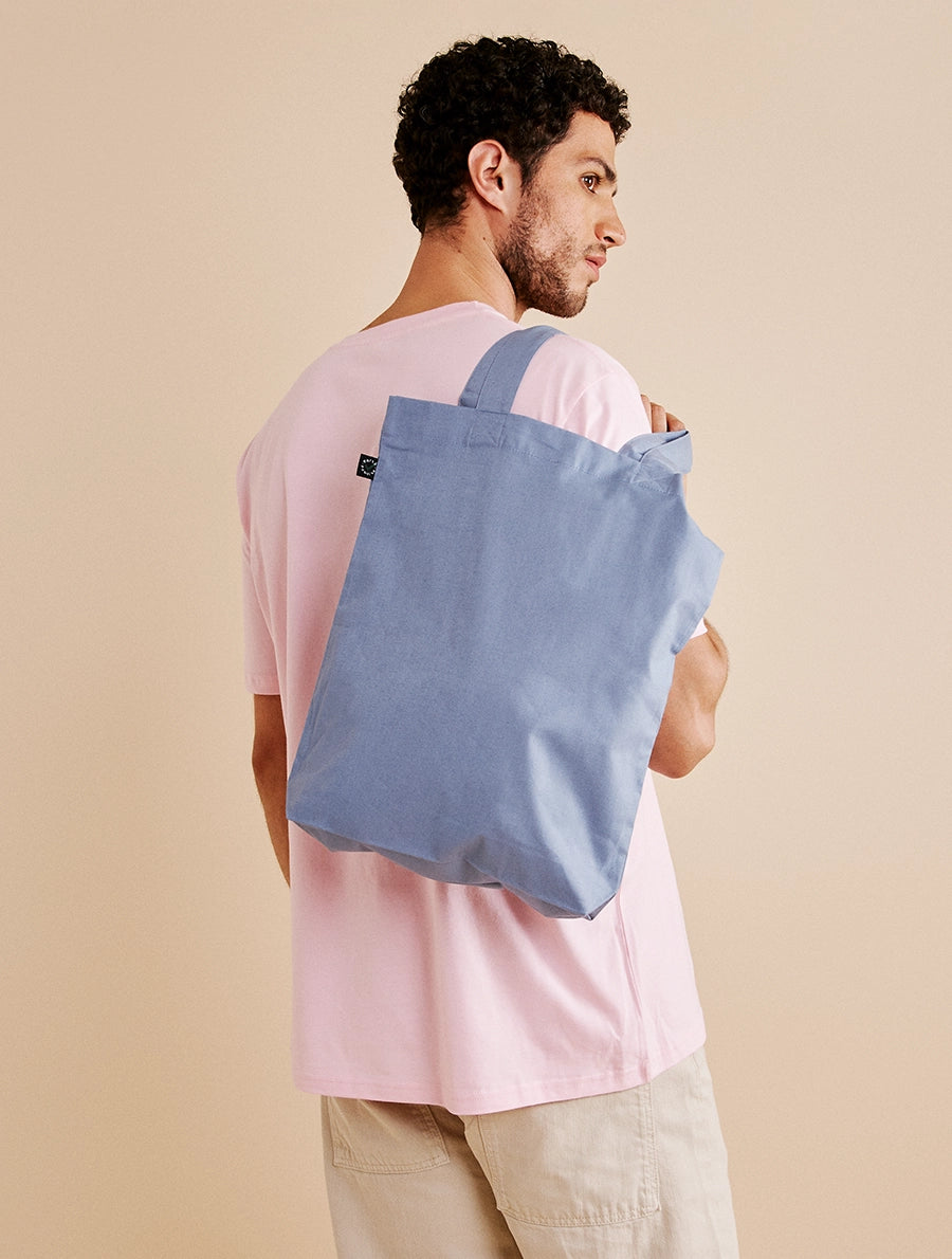 Model wearing Earth Positive Sustainable T-Shirt and Tote Bag